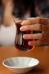 woman holding a cup of tea, tasty drink
