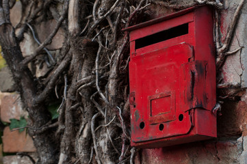 Red old mailbox on the wall. Letter boxes.