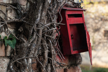 Red old mailbox on the wall. Letter boxes.