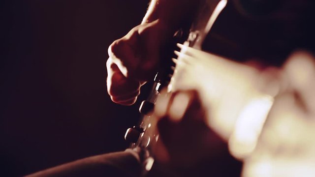 Man playing the guitar, hand close-up