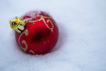 Christmas balls in the snow on white Beautiful Christmas bauble decorations lie on the white fluffy...