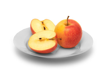 Naklejka na ściany i meble Whole apple and cut in half apple on white plate with white background