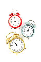 Collection of bright colorful alarm clocks over the white background