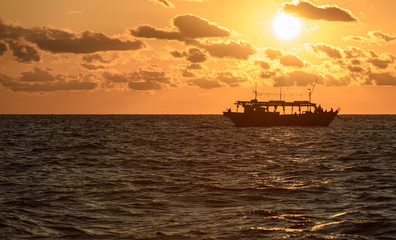 Fishing schooner at sunset