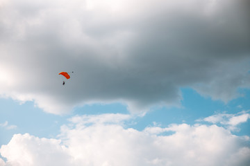 Naklejka na ściany i meble Paratrooper parachuting in blue sky. Military service
