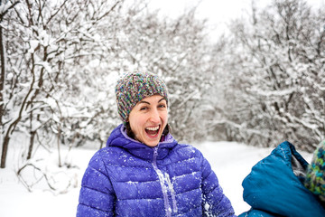 The girl plays snowballs.