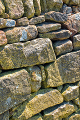 Stone wall. Abstract dry stones in boundary wall in Derbyshire Peak District countryside.  Stone material construction, natural and textured.