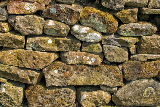 Stone wall. Abstract dry stones in boundary wall in Derbyshire Peak District countryside.  Stone material construction, natural and textured.