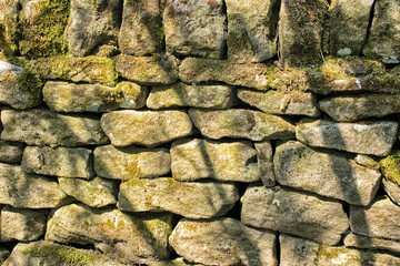 Stone wall. Abstract dry stones in boundary wall in Derbyshire Peak District countryside.  Stone material construction, natural and textured.