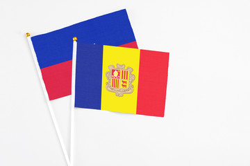 Andorra and Haiti stick flags on white background. High quality fabric, miniature national flag....