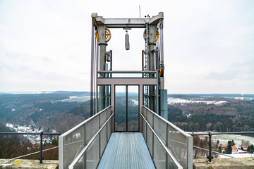 Public glass elevator on viewing platform outdoor
