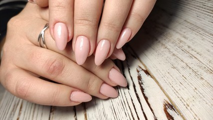 fashionable beige manicure with a silver design