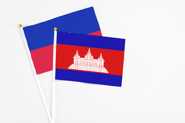 Cambodia and Haiti stick flags on white background. High quality fabric, miniature national flag....