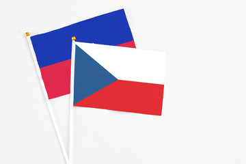 Czech Republic and Haiti stick flags on white background. High quality fabric, miniature national flag. Peaceful global concept.White floor for copy space.