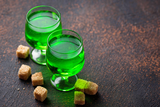 Glasses of absinthe with brown sugar