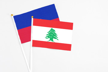 Lebanon and Haiti stick flags on white background. High quality fabric, miniature national flag....