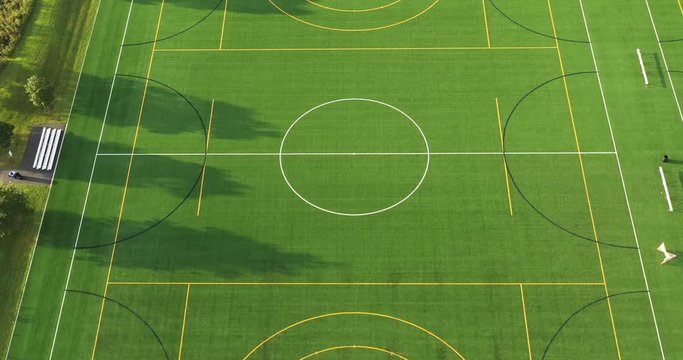 Aerial view of a soccer field in early morning light.