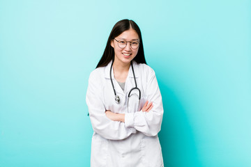 Young chinese doctor woman laughing and having fun.