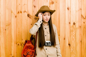 Young chinese traveler woman being shocked, she has remembered important meeting.