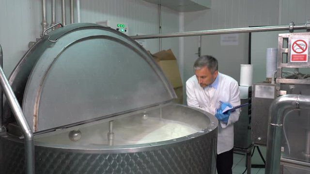 Dairy Plant Technologist Checking Milk Pasteurization Process