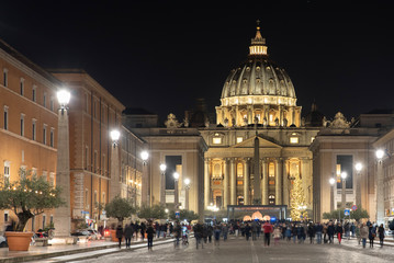 Fototapeta na wymiar View of the Papal Basilica of St. Peter's in the Vatican illuminated at night (St. Peter's Cathedral) in Rome, Italy.
