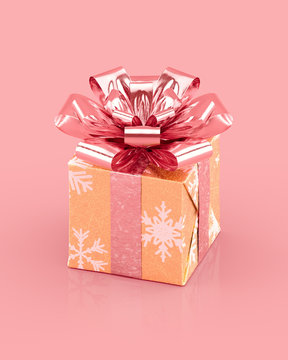 Golden Christmas gift box with sparkling pink bow and ribbons. Snowflakes pattern on paper. Realistic 3D rendering.