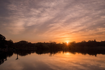 Fototapeta na wymiar sunrise at park with lake and clouds