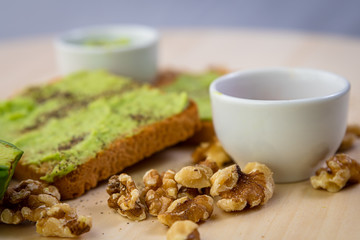 toasted bread with avocado ,red hot chilli,nuts and pepper 