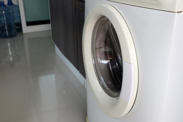 Closeup of washing machine door in laundry room.