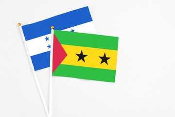 Sao Tome And Principe and Honduras stick flags on white background. High quality fabric, miniature national flag. Peaceful global concept.White floor for copy space.