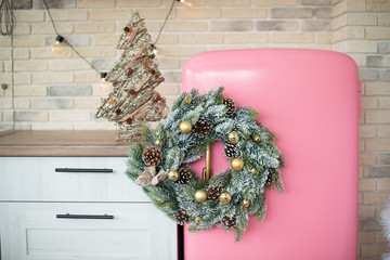 Retro style pink fridge in vintage kitchen with Christmas decor. Christmas kitchen.