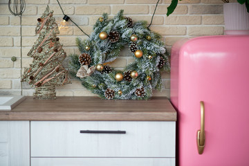 Retro style pink fridge in vintage kitchen with Christmas decor. Christmas kitchen.