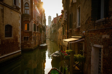 Fototapeta na wymiar Venice canal at dawn with boats and old architecture
