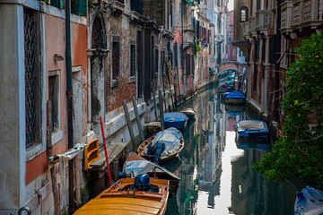 Fototapeta na wymiar Venice canal with boats and old architecture