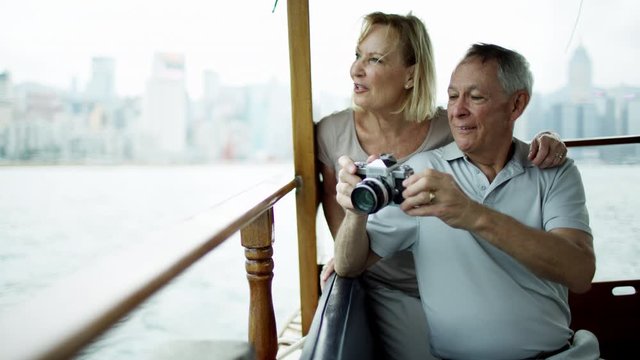 Couple taking travel photographs with camera Hong Kong