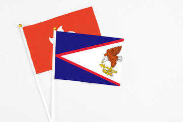 American Samoa and Hong Kong stick flags on white background. High quality fabric, miniature...