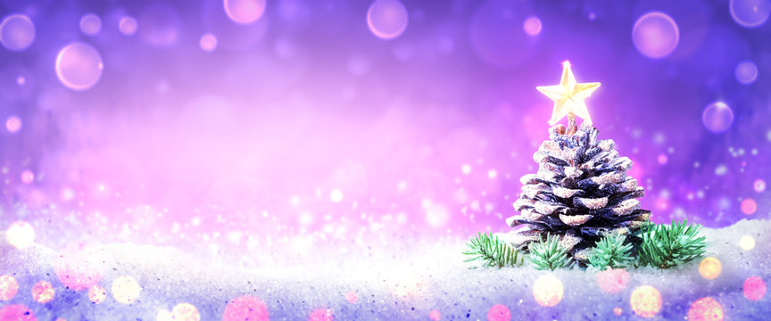 Frosty Pine Cone On Snow With Bright Shining Star And Soft Bokeh Background - Christmas Concept
