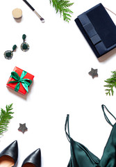 Christmas or New Year fashion party concept frame with clothes and accesories. Preparation for winter holiday events on the white background. Festive shopping composition top view. Copy space