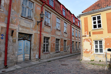 Fototapeta na wymiar Old city streets traditional baltic tourism architecture house facades in historical part of town with stone road and colorful original buildings