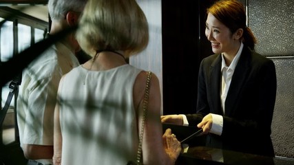 Caucasian seniors using Hong Kong hotel concierge service 