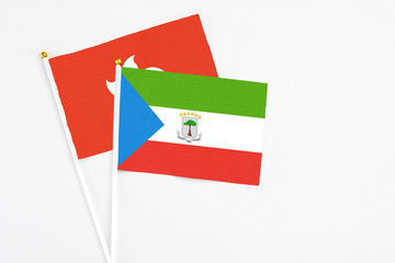 Equatorial Guinea and Hong Kong stick flags on white background. High quality fabric, miniature national flag. Peaceful global concept.White floor for copy space.