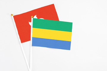 Gabon and Hong Kong stick flags on white background. High quality fabric, miniature national flag....