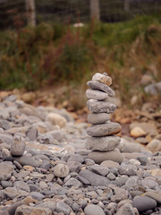 Tall balance stone tower against organic nature background. Concept patience at reaching your target.