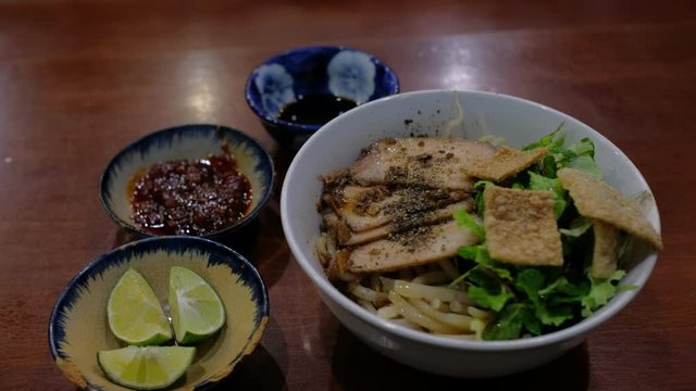 Cao lau is a regional Vietnamese dish made with noodles, pork, local greens. Royalty high-quality free stock video footage of Cao Lau noodle in Hoi An old town, Vietnam, it's a favorite dish in Hoi An