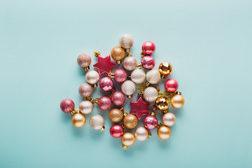 A lot of Christmas balls of pink and gold color.