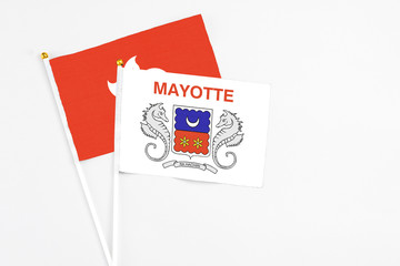 Mayotte and Hong Kong stick flags on white background. High quality fabric, miniature national flag. Peaceful global concept.White floor for copy space.
