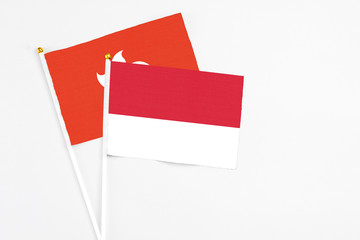 Monaco and Hong Kong stick flags on white background. High quality fabric, miniature national flag. Peaceful global concept.White floor for copy space.