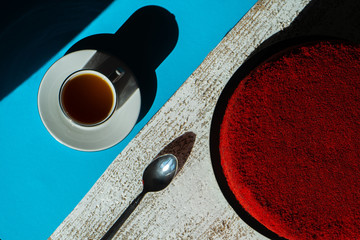 red velvet pie. red cake. cake with a cup of tea on a turquoise background with a place for...