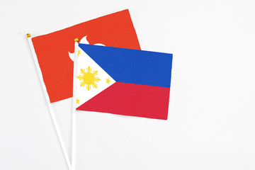 Philippines and Hong Kong stick flags on white background. High quality fabric, miniature national flag. Peaceful global concept.White floor for copy space.