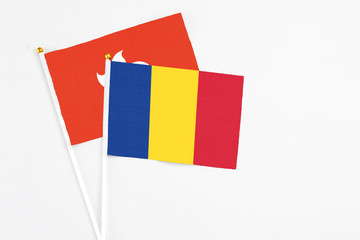 Romania and Hong Kong stick flags on white background. High quality fabric, miniature national flag. Peaceful global concept.White floor for copy space.